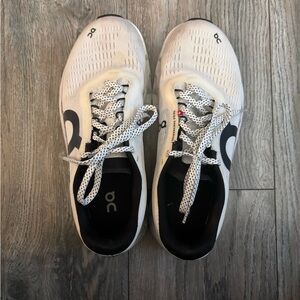 On Running Cream and Black Athletic Shoes